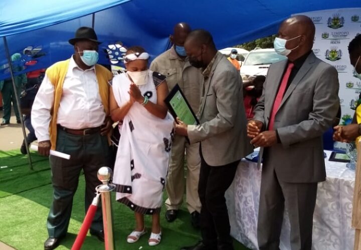 Hosi Shigamani reacts after receiving a certificate for Covid -19 vaccination compliance